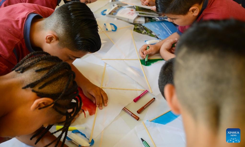 Students design their kites during the Chinese kite festival in Kalkara, Malta, on June 22, 2022. The Esplora Interactive Science Center in Malta was bustling with activities on Wednesday as students from primary schools got a break from the classroom to attend the 4th edition of the Chinese kite festival.(Photo: Xinhua)