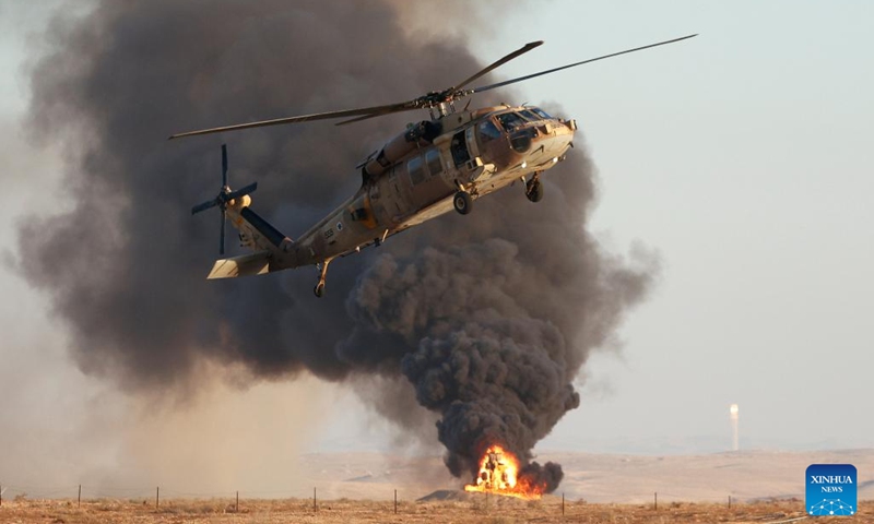 A helicopter performs during an Israeli Air Force (IAF) graduation ceremony at Hatzerim Airbase near Be'er Sheva, Israel, on June 23, 2022.(Photo: Xinhua)