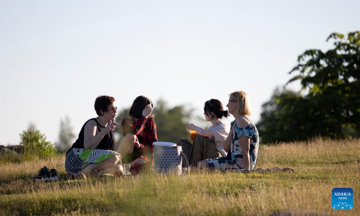 People celebrate Midsummer eve at Kaivopuisto Park in Helsinki, Finland, June 24, 2022. Midsummer Festival is an important festival and also one of the national holidays in Finland. Photo:Xinhua