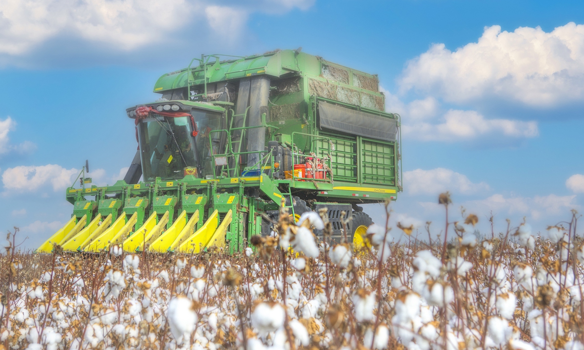 A harvester picks cotton in Urumqi, capital of Xinjiang region. Photo: VCG