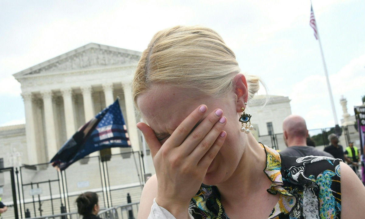 A woman cries outside the US Supreme Court in Washington, DC, on June 24, 2022, when the conservative-dominated court ended the right to abortion in a seismic ruling that shreds half a century of constitutional protections in one of the most divisive and bitterly fought issues in American political life. Photo: AFP