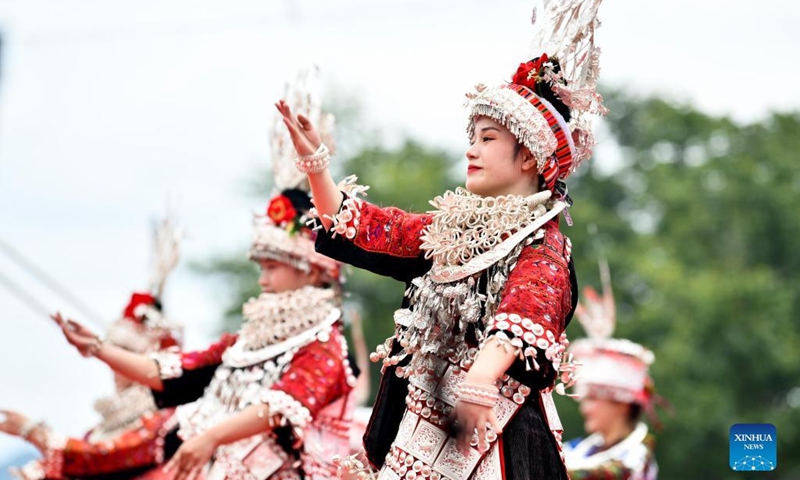 People of Miao ethic group dance during the opening ceremony of the canoe dragon boat festival in Shidong Town, Taijiang County of southwest China's Guizhou Province, June 23, 2022. The yearly canoe dragon boat festival of Miao ethnic group was held here on Thursday. (Xinhua/Yang Wenbin)