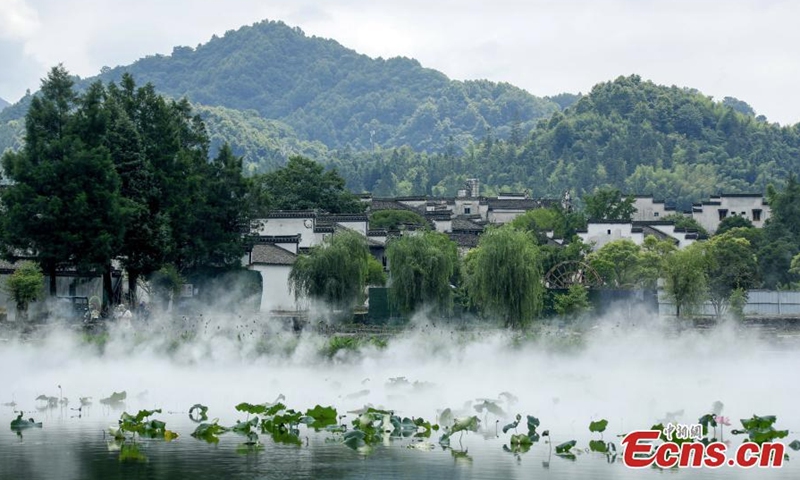 Photo shows charming after-rain scenery of Xidi Village, a traditional Chinese village,in Yixian County of Huangshan City, east China's Anhui Province, June 23, 2022. Xidi Village was built nearly 1,000 years ago and is home to 224 well-preserved Hui-style ancient wooden dwellings. It was named Best Tourism Villages 2021 by the World Tourism Organization and listed as a UNESCO world heritage site in 2000.(Photo: China News Service/Shi Yalei)