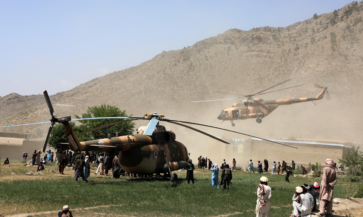 Afghans receive humanitarian aid after a powerful earthquake hit eastern Afghanistan before dawn on June 22 in Paktika, Afghanistan on June 24. A local official said that the search for survivors has been completed, with 1,150 deaths and at least 1,600 injured. 