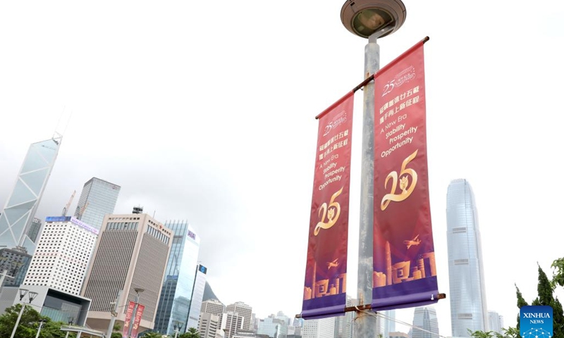 Celebratory posters are seen at a street in Hong Kong, south China, June 19, 2022. This year marks the 25th anniversary of Hong Kong's return to the motherland.(Photo: Xinhua)