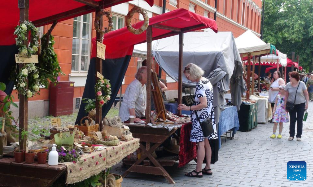 A tourist visits a stall at the annual Medieval Market in Turku, Finland, June 30, 2022. The annual Medieval Market, one of the largest historical events in Finland, kicked off on Thursday. Visitors enjoy a robust medieval atmosphere with stall owners and actors dressed in medieval style costumes at the market. Photo:Xinhua