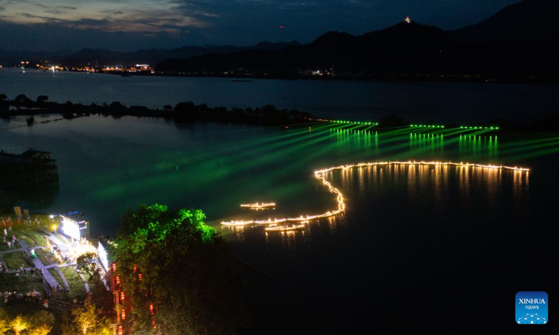 Aerial photo taken on July 3, 2022 shows lights on fishing boats during a folk festival in Sandu Fishing Village of Jiande City, east China's Zhejiang Province. (Xinhua/Xu Yu)