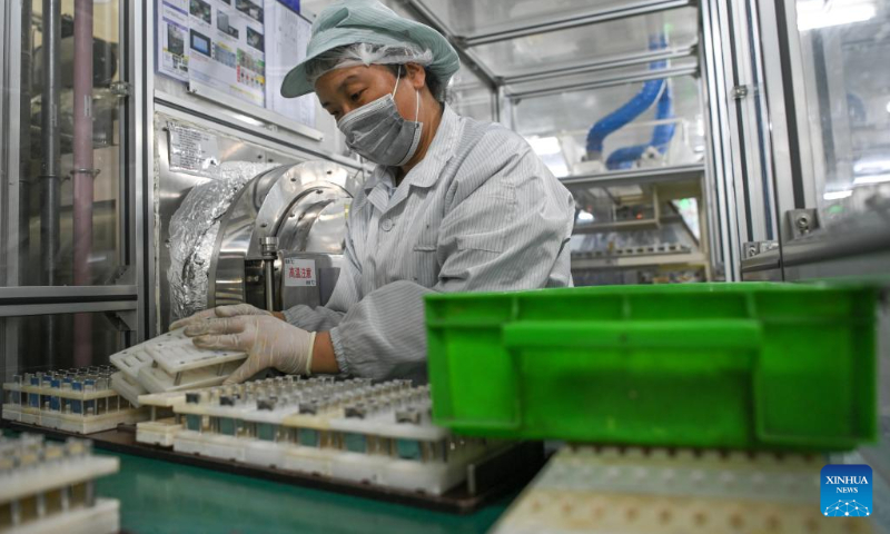 A worker is busy at a battery assembly workshop at Panasonic Energy (Wuxi) Co. Ltd. in Wuxi, east China's Jiangsu Province, July 5, 2022. Wuxi has been making every effort to ensure production and stable operation with epidemic control and prevention measures. (Xinhua/Li Bo)