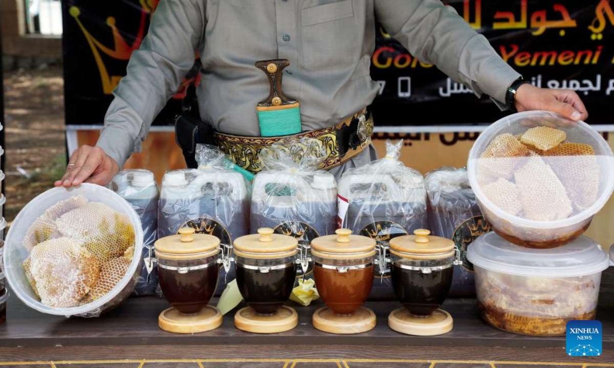 A seller displays his honey products at a honey festival in Sanaa, capital of Yemen, on June 30, 2022. Photo:Xinhua