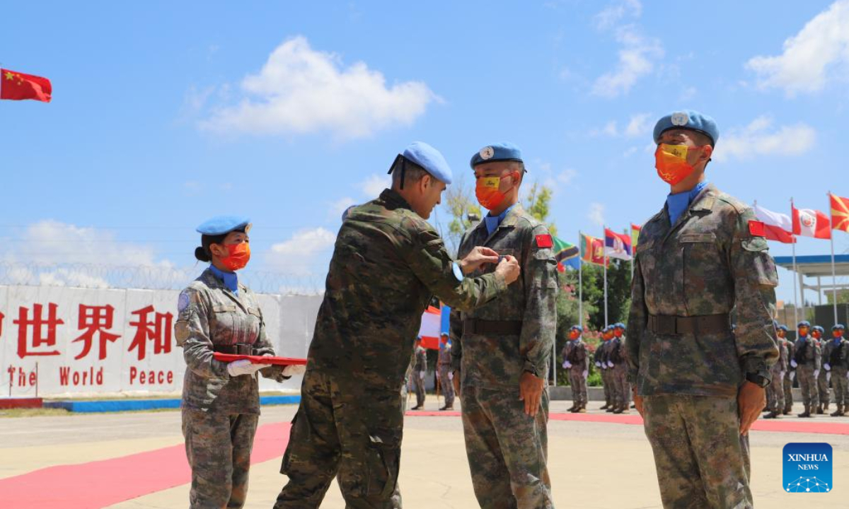 Aroldo Lazaro Saenz, UN Interim Force in Lebanon (UNIFIL) head of Mission and Force Commander, presents a UN medal of peace to a member of the 20th Chinese peacekeeping contingent to Lebanon at a medal parade ceremony in Hanniyah village, southern Lebanon, July 1, 2022. Photo:Xinhua