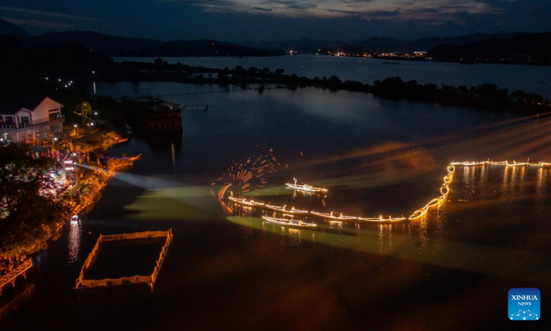 Aerial photo taken on July 3, 2022 shows lights on fishing boats during a folk festival in Sandu Fishing Village of Jiande City, east China's Zhejiang Province. (Xinhua/Xu Yu)