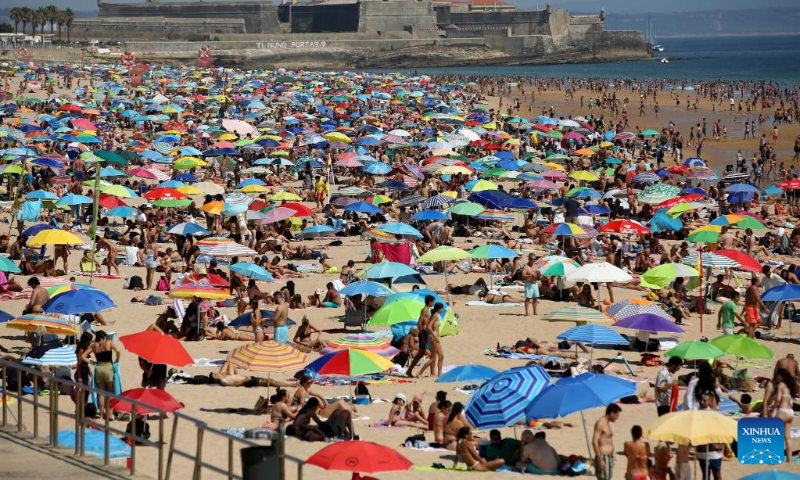 People cool off at the Carcavelos beach in Cascais, Portugal, July 9, 2022. (Photo by Pedro Fiuza/Xinhua)