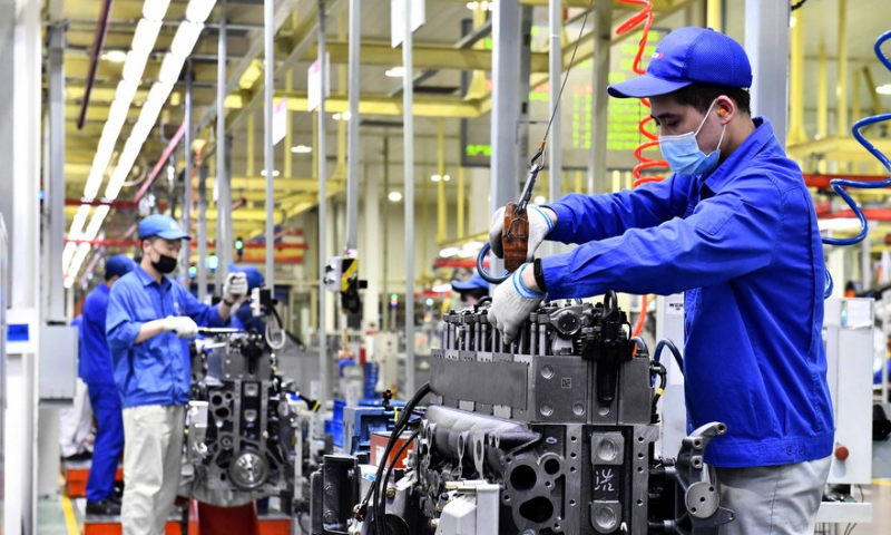 Workers assemble engines on an assembly line at a workshop of the Weichai Power Co., Ltd. in Weifang City, east China's Shandong Province, April 22, 2021. Photo: Xinhua