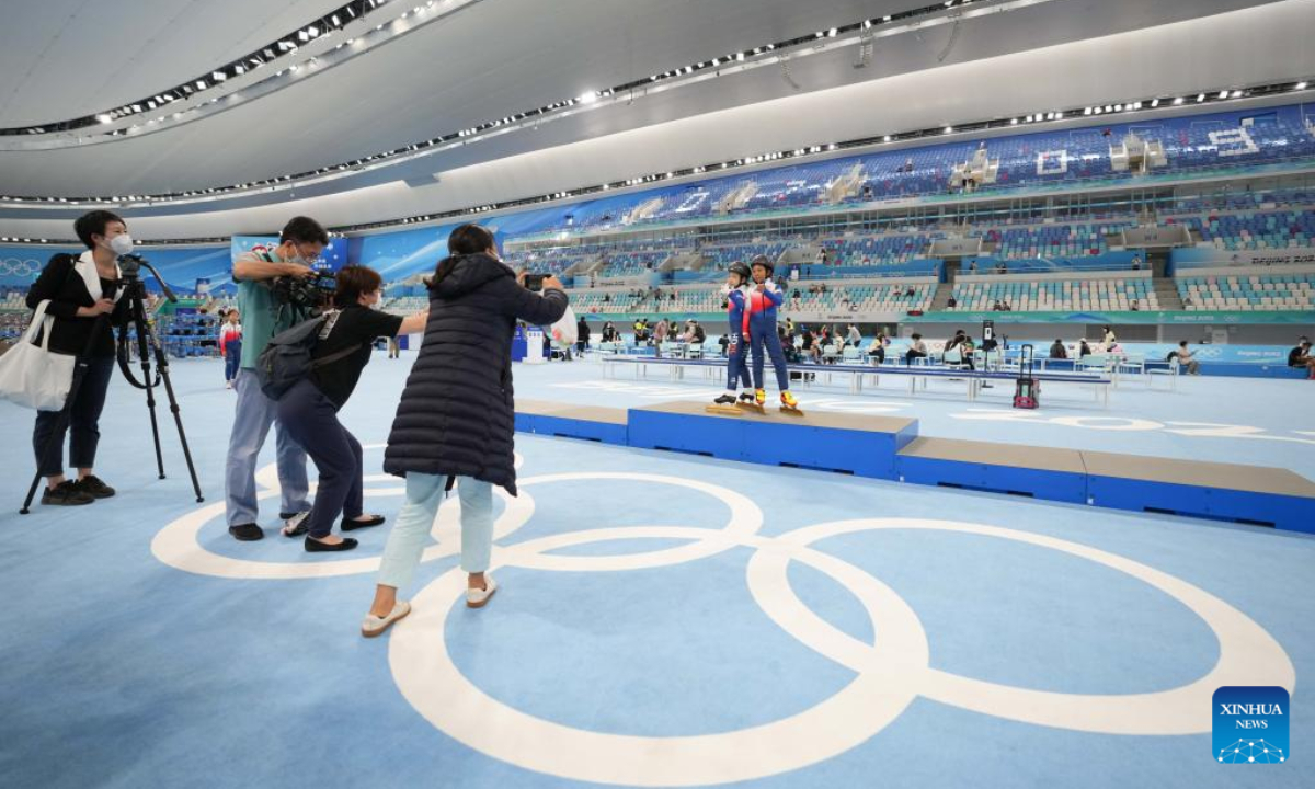 Two children pose for photos at the National Speed Skating Oval in Beijing, capital of China, July 9, 2022. The National Speed Skating Oval, also known as the Ice Ribbon, opened to the public on Saturday. Photo:Xinhua