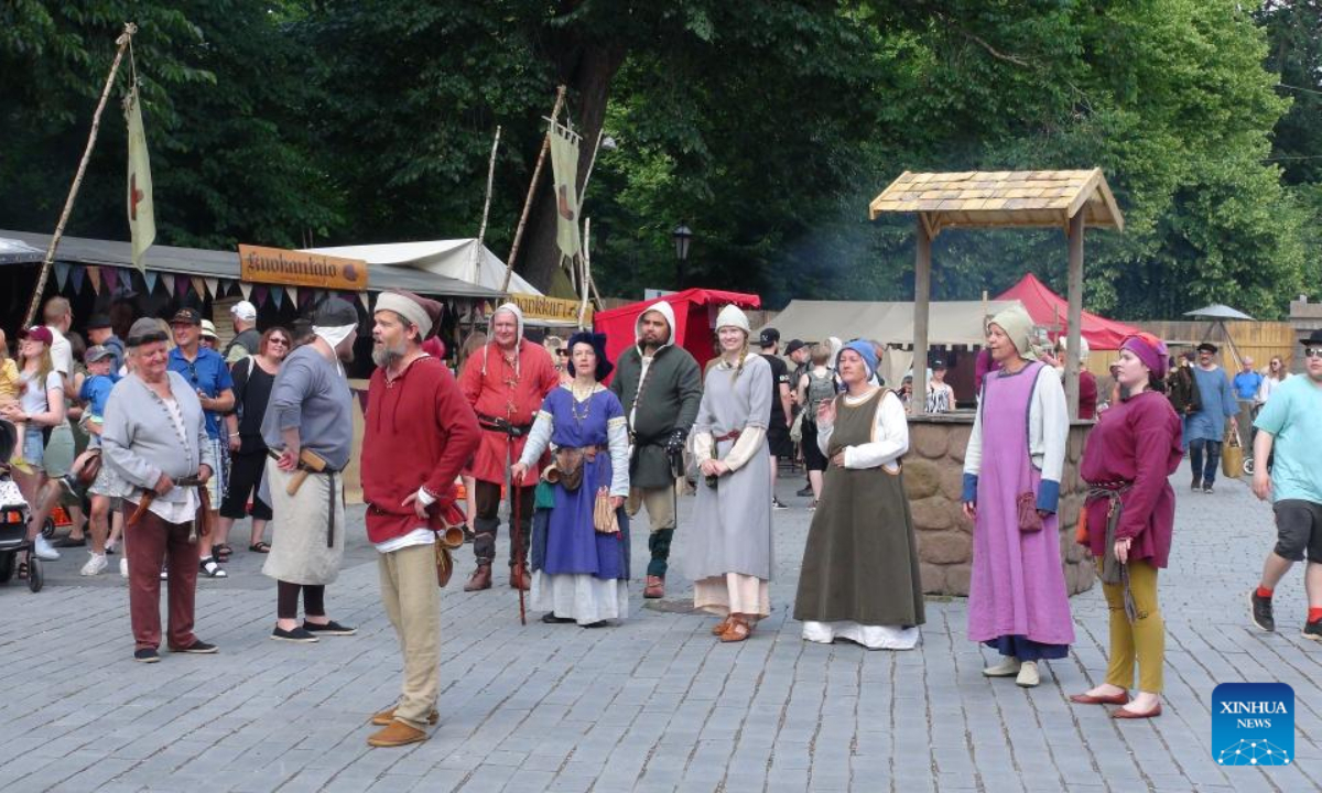 Actors dressed in medieval style costumes perform scenes of life in medieval Turku at the annual Medieval Market in Turku, Finland, June 30, 2022. The annual Medieval Market, one of the largest historical events in Finland, kicked off on Thursday. Visitors enjoy a robust medieval atmosphere with stall owners and actors dressed in medieval style costumes at the market. Photo:Xinhua