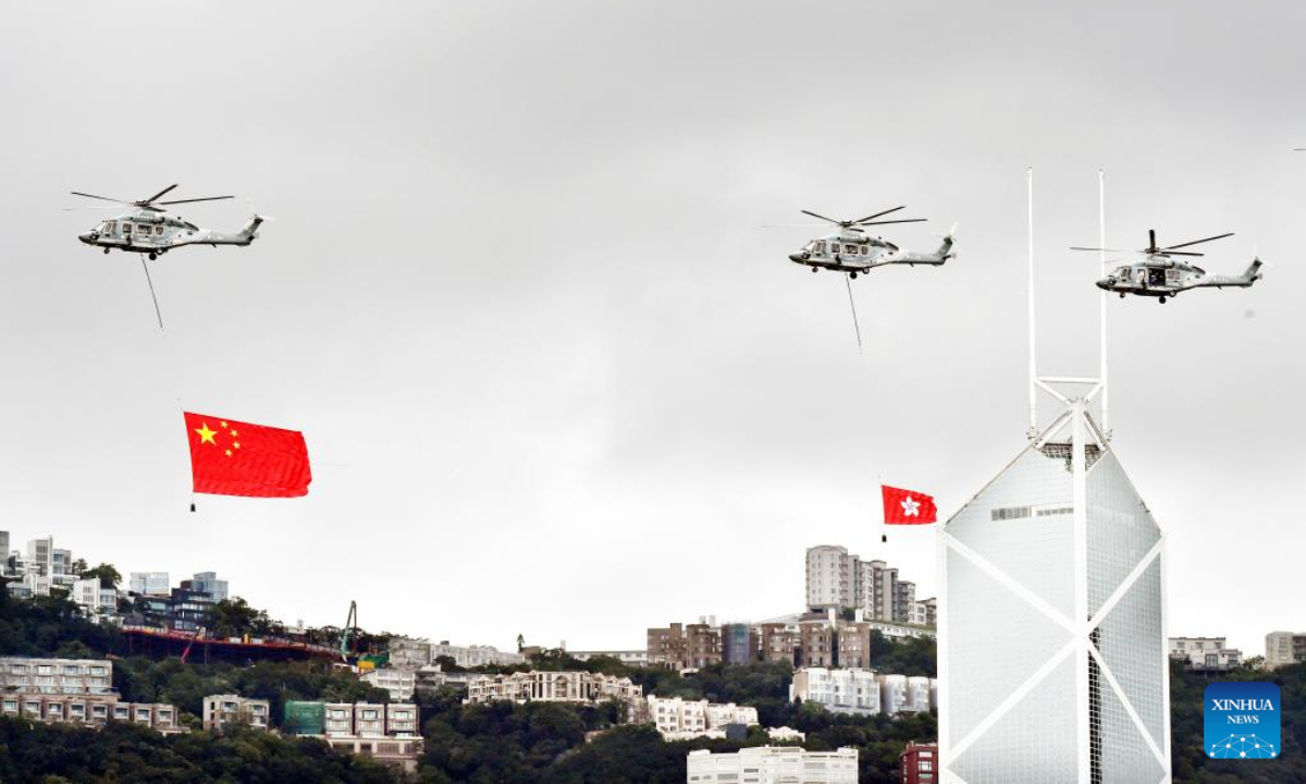 Helicopters carrying China's national flag and the flag of the Hong Kong Special Administrative Region fly over Hong Kong, south China, July 1, 2022. A flag-raising ceremony was held by the government of the Hong Kong Special Administrative Region to celebrate the 25th anniversary of Hong Kong's return to the motherland on Friday morning. Photo:Xinhua