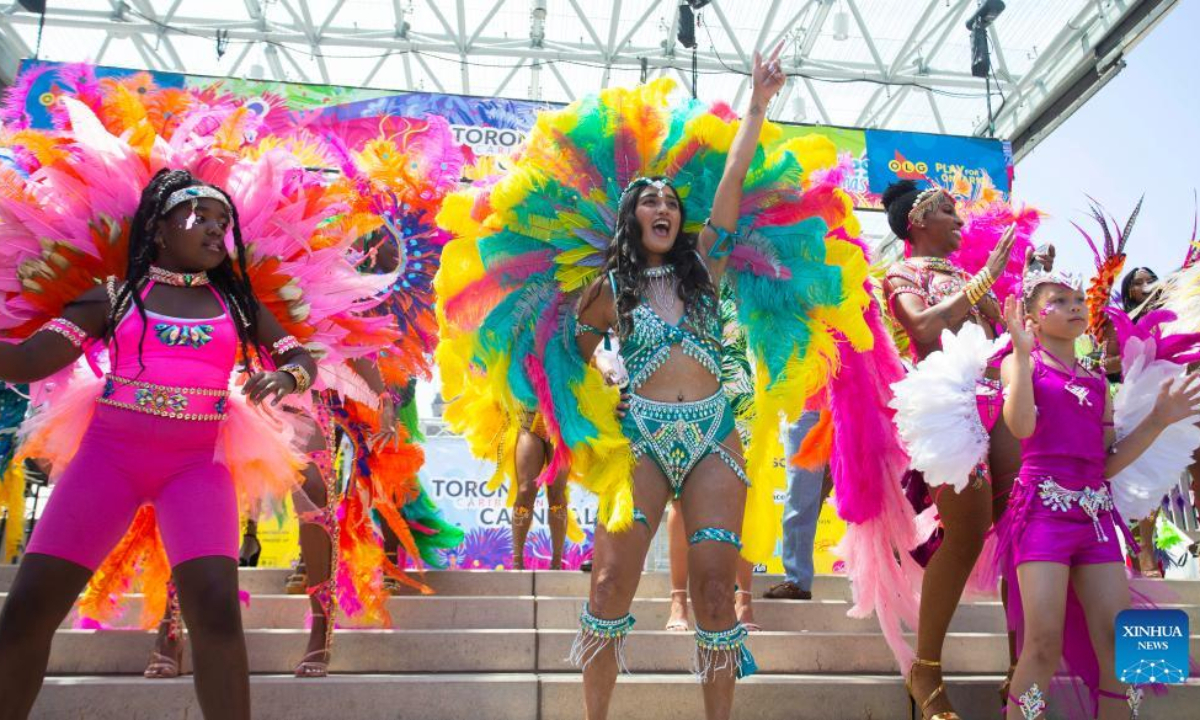 Dressed-up revelers dance during the official launch ceremony of the 2022 Toronto Caribbean Carnival in Toronto, Canada, on July 7, 2022. As a spectacular display of Caribbean music, costumes and culture, the annual event is held here from July 7 to July 31. Photo:Xinhua