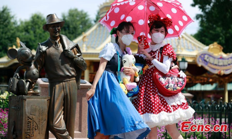 Visitors take photos at the Shanghai Disneyland theme park as it reopens in Shanghai, June 30, 2022. (Photo: China News Service/Tang Yanjun)