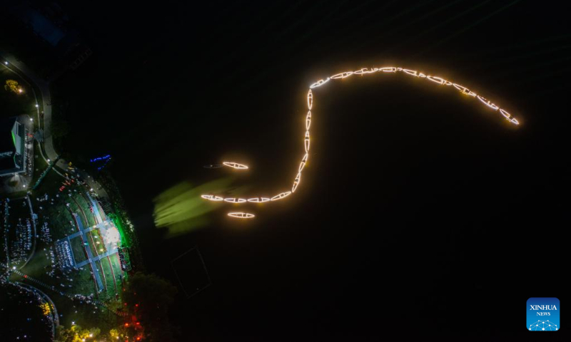 Aerial photo taken on July 3, 2022 shows lights on fishing boats during a folk festival in Sandu Fishing Village of Jiande City, east China's Zhejiang Province. (Xinhua/Xu Yu)