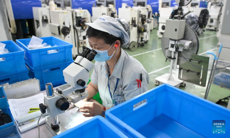 A worker is busy at a parts production workshop of a subsidiary of Alps Alpine in Wuxi, east China's Jiangsu Province, July 5, 2022. Wuxi has been making every effort to ensure production and stable operation with epidemic control and prevention measures. (Xinhua/Li Bo)