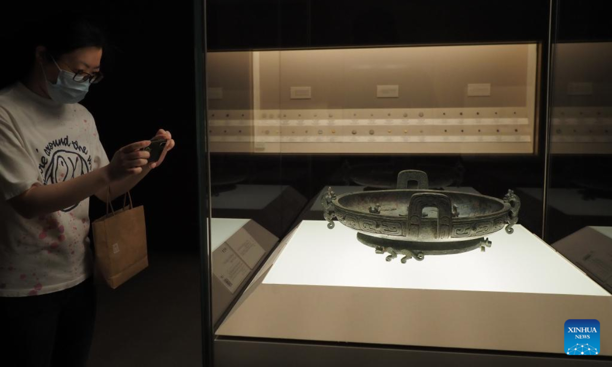 A visitor takes photos of an exhibit at Shanghai Museum in Shanghai, east China, July 1, 2022. Photo:Xinhua
