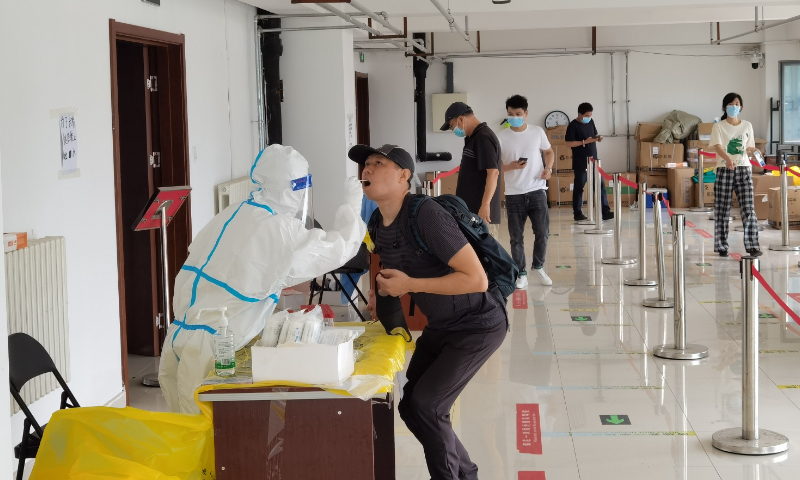 Residents of Beijing's Shijingshan district take nucleic acid tests on July 6, 2022. Photo: IC
