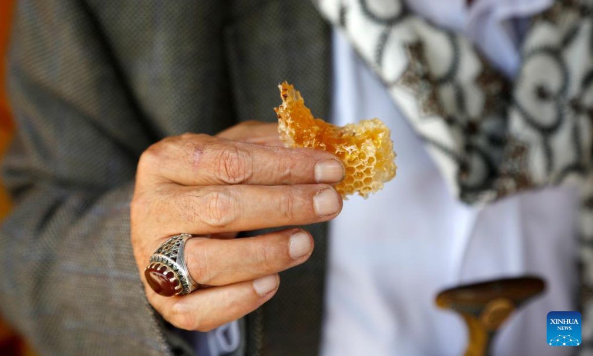 A seller displays his honey products at a honey festival in Sanaa, capital of Yemen, on June 30, 2022. Photo:Xinhua