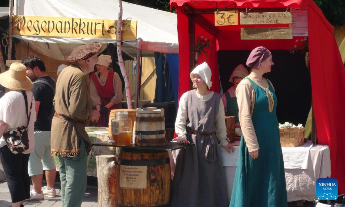 Stall owners dressed in medieval style costumes are seen at the annual Medieval Market in Turku, Finland, June 30, 2022. The annual Medieval Market, one of the largest historical events in Finland, kicked off on Thursday. Visitors enjoy a robust medieval atmosphere with stall owners and actors dressed in medieval style costumes at the market. Photo:Xinhua