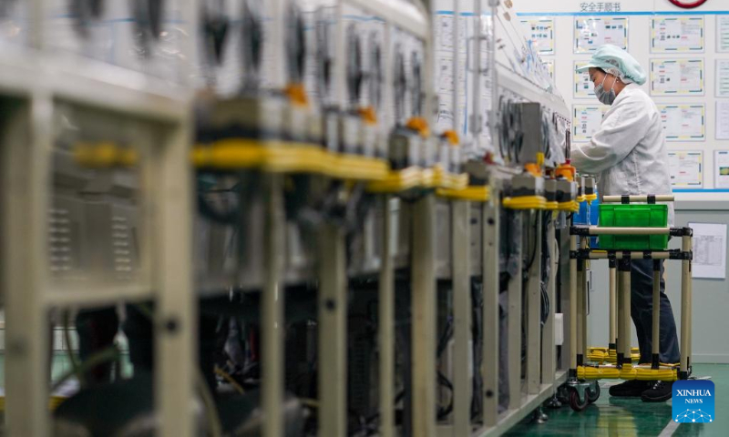 A worker is busy at a battery assembly workshop at Panasonic Energy (Wuxi) Co. Ltd. in Wuxi, east China's Jiangsu Province, July 5, 2022. Wuxi has been making every effort to ensure production and stable operation with epidemic control and prevention measures. (Xinhua/Li Bo)