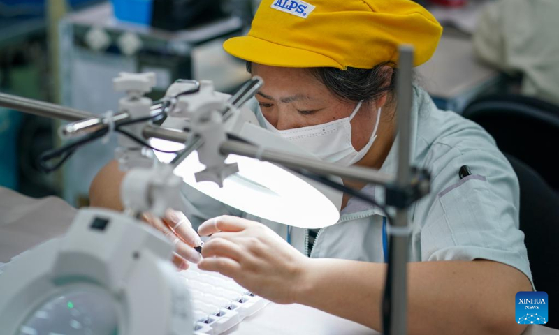 A worker is busy at an electronic switch production and assembly workshop of a subsidiary of Alps Alpine in Wuxi, east China's Jiangsu Province, July 5, 2022. Wuxi has been making every effort to ensure production and stable operation with epidemic control and prevention measures. (Xinhua/Li Bo)