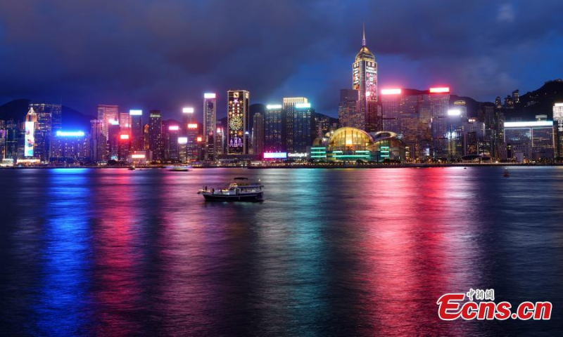 Photo shows night view at the Victoria Harbor, the Hong Kong Special Administrative Region, June 29, 2022. Light installations were illuminated to celebrate the 25th anniversary of Hong Kong's return to the motherland on Wednesday. (Photo: China News Service/Zhang Wei )