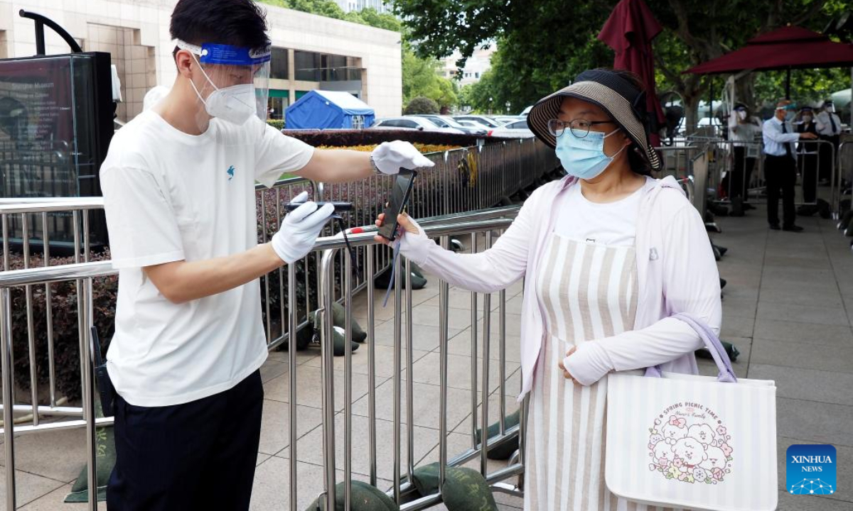 A visitor has her health code checked before entering Shanghai Museum in Shanghai, east China, July 1, 2022. Photo:Xinhua