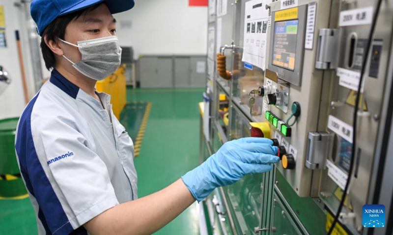 A worker operates a machine at a battery assembly workshop at Panasonic Energy (Wuxi) Co. Ltd. in Wuxi, east China's Jiangsu Province, July 5, 2022. Wuxi has been making every effort to ensure production and stable operation with epidemic control and prevention measures. (Xinhua/Li Bo)