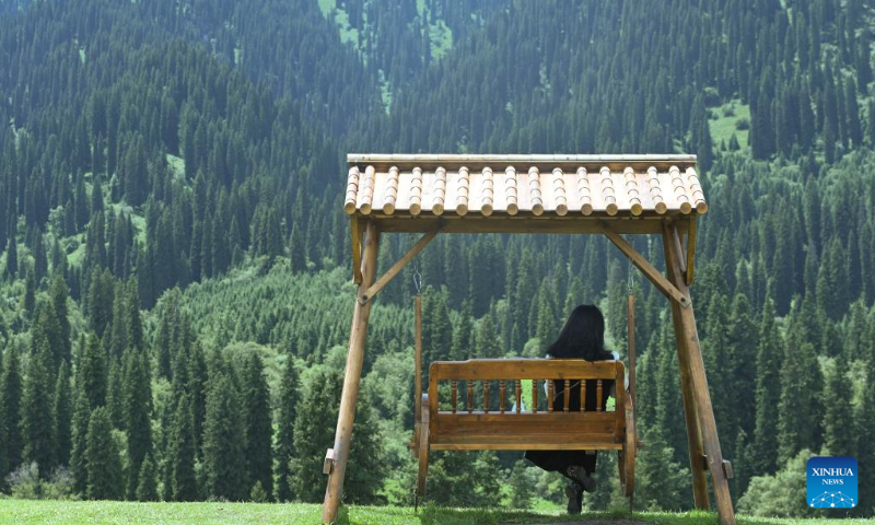 A visitor enjoys herself at the Narat scenic spot in Xinyuan County, northwest China's Xinjiang Uygur Autonomous Region, June 28, 2022. (Xinhua/Hao Jianwei)