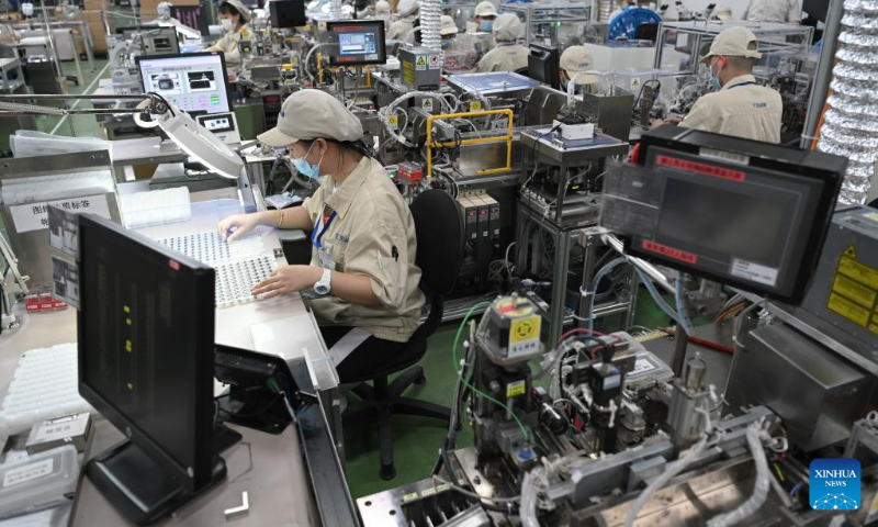 Workers are busy at an electronic switch production and assembly workshop of a subsidiary of Alps Alpine in Wuxi, east China's Jiangsu Province, July 5, 2022. Wuxi has been making every effort to ensure production and stable operation with epidemic control and prevention measures. (Xinhua/Li Bo)