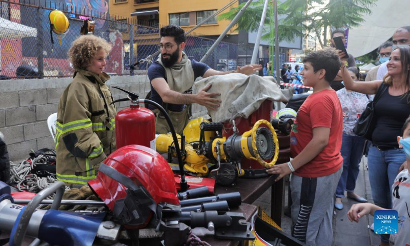A firefighter promotes firefighting knowledge at the Life Beat Festival at the Hamra street in Beirut, Lebanon, June 26, 2022. (Xinhua/Liu Zongya)