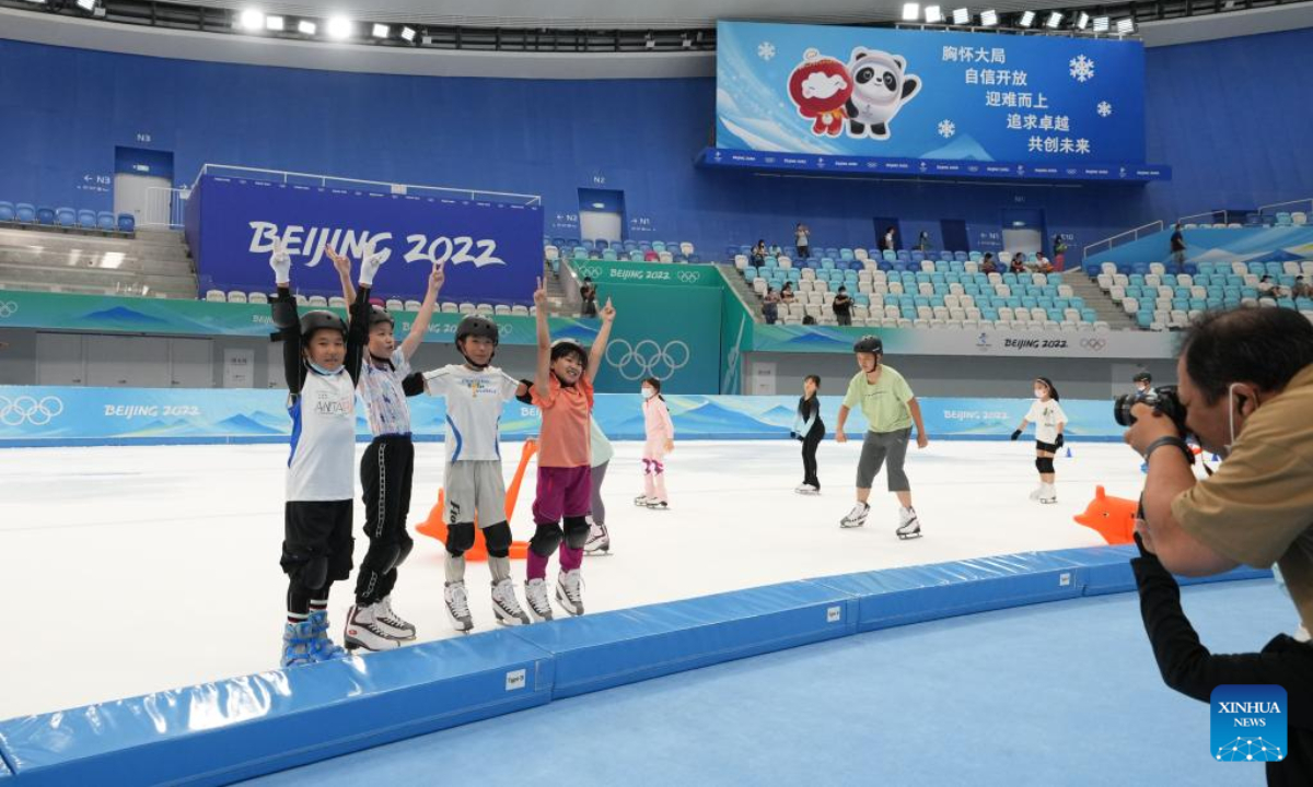 Children pose for photos at the National Speed Skating Oval in Beijing, capital of China, July 9, 2022. The National Speed Skating Oval, also known as the Ice Ribbon, opened to the public on Saturday. Photo:Xinhua