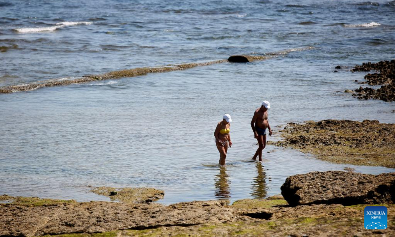 People cool off in water at the Carcavelos beach in Cascais, Portugal, July 9, 2022. (Photo by Pedro Fiuza/Xinhua)