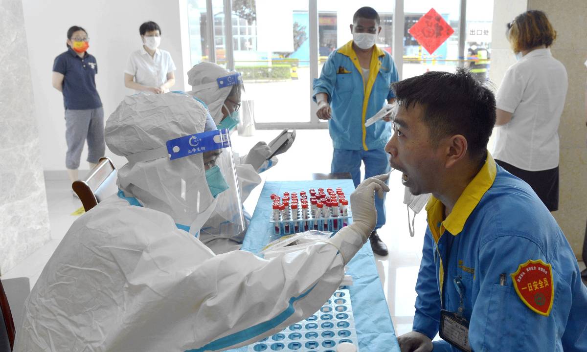 A medical worker takes a swab sample from a resident in Wuxi, East China's Jiangsu Province, on July 1. Photo: VCG