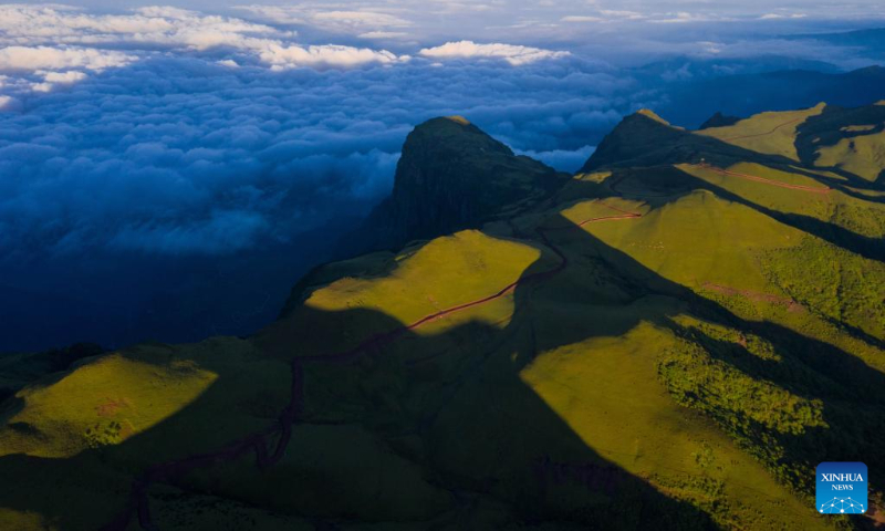 Aerial photo taken on July 7, 2022 shows clouds floating at sunrise in Mount Longtou in the border area between Leibo County and Meigu County, southwest China's Sichuan Province. The mountain reaches an altitude of 3,724 meters. (Xinhua/Jiang Hongjing)