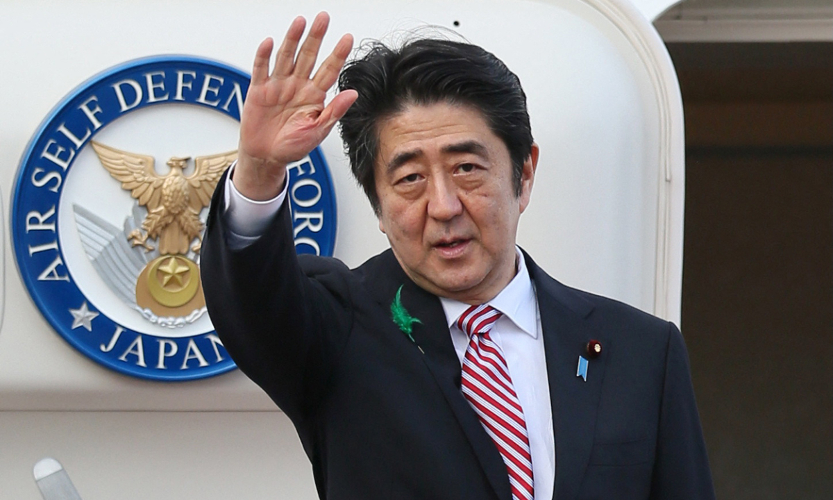 In this file photo taken on April 21, 2015, Japanese Prime Minister Shinzo Abe waves as he heads to Indonesia at Tokyo International Airport.  Photo: AFP
