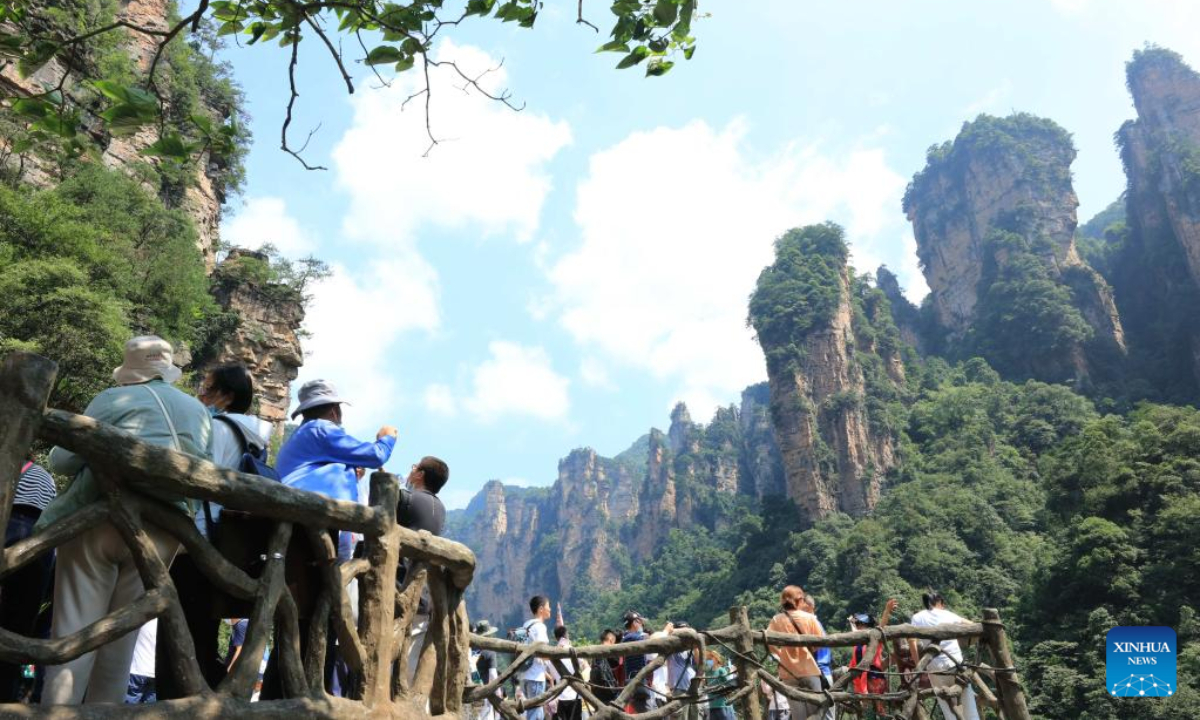 Tourists visit the Wulingyuan scenic area in Zhangjiajie, central China's Hunan Province, July 8, 2022. As the summer vacation approaches, Zhangjiajie, a popular tourist destination in Hunan Province, has taken a series of measures to boost the recovery of tourism. Photo:Xinhua