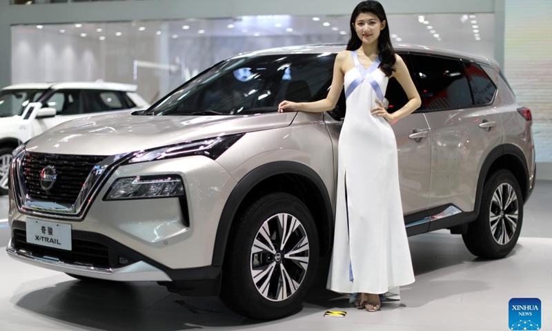 A model poses with a showcased vehicle during the Shenyang (China) International Automobile Industry Expo 2022 in Shenyang, northeast China's Liaoning Province, June 26, 2022.Photo:Xinhua