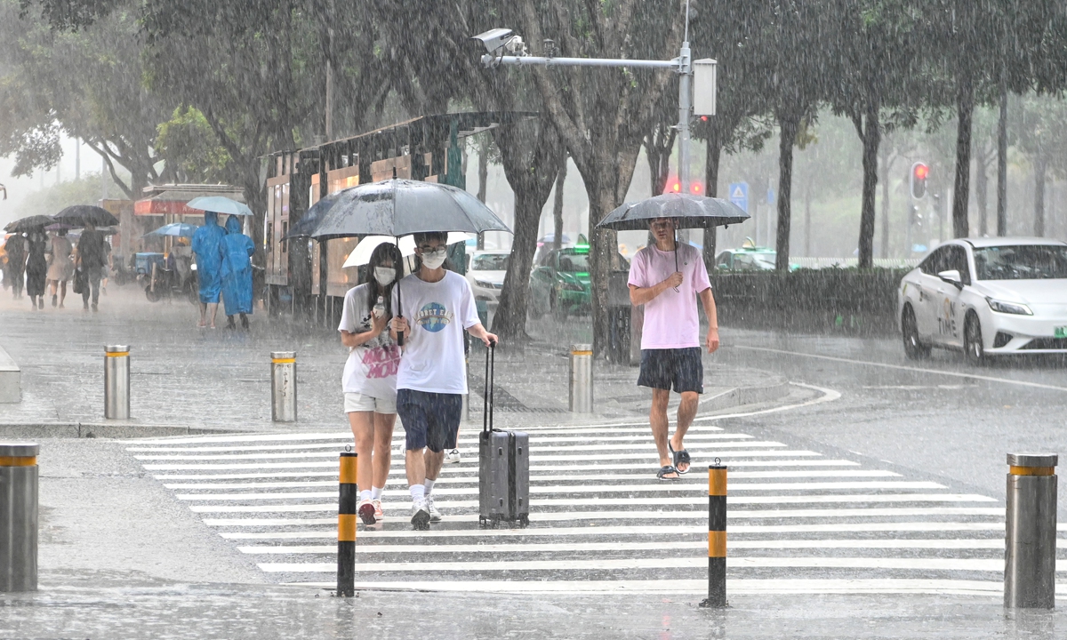Residents walk on streets in Guangzhou, South China's Guangdong Province in heavy rain on July 3, 2022, after typhoon Chaba made landfall in Guangdong. Chaba is the first typhoon to make landfall in China in 2022. Photo: cnsphoto
