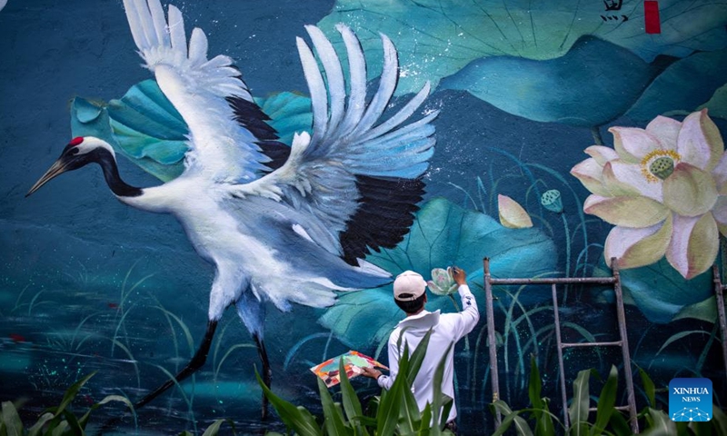 Liu Zhicheng works on a wall painting in Yongsheng County, Lijiang City, southwest China's Yunnan Province, June 24, 2022.Photo:Xinhua