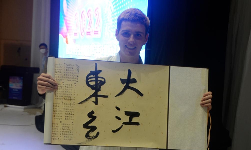A contestant shows his calligraphy work during the Chinese Bridge Chinese proficiency competition for university and secondary students at the Confucius Institute of Makerere University in Kampala, Uganda, June 25, 2022.Photo:Xinhua