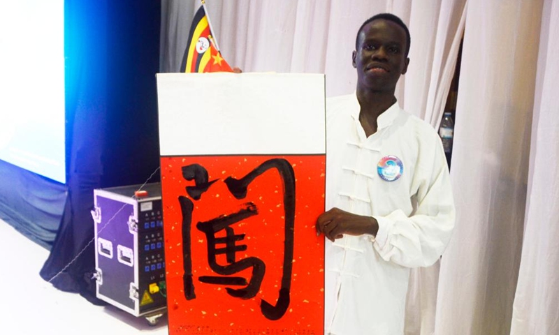 A contestant shows his calligraphy work during the Chinese Bridge Chinese proficiency competition for university and secondary students at the Confucius Institute of Makerere University in Kampala, Uganda, June 25, 2022.Photo:Xinhua