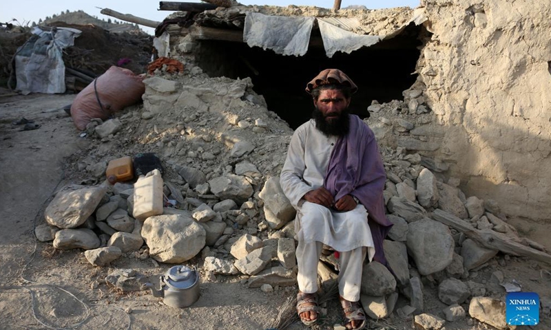 A man sits on the rubble of a house damaged in an earthquake in Khost province, Afghanistan, on June 26, 2022.Photo:Xinhua