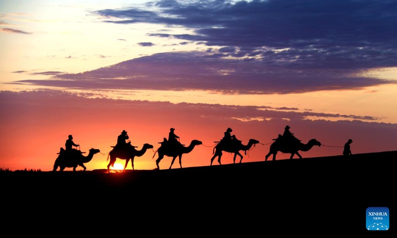 People visit Mingsha Mountain and Crescent Spring scenic spot in Dunhuang City, northwest China's Gansu Province, June 27, 2022.(Photo: Xinhua)