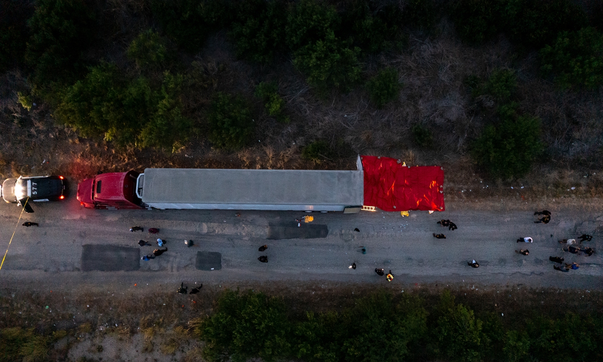 In this aerial view, members of law enforcement investigate a tractor trailer in San Antonio, Texas on June 27, 2022. Photo: AFP